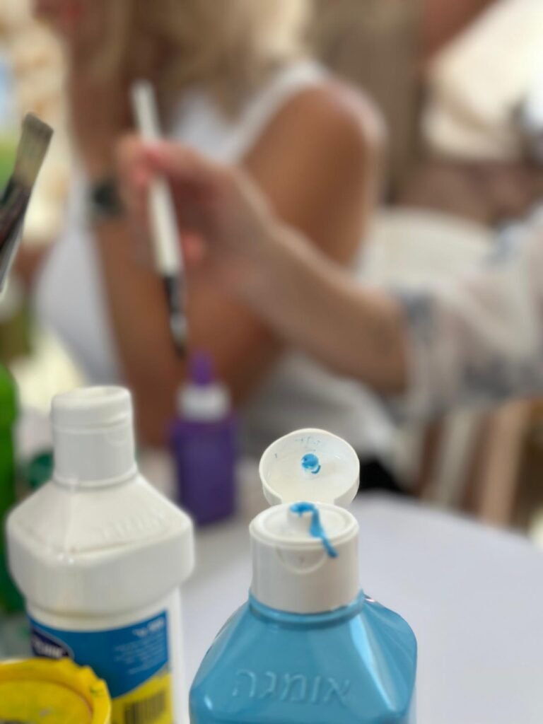 Assorted Bottles of Paint and Brushes
