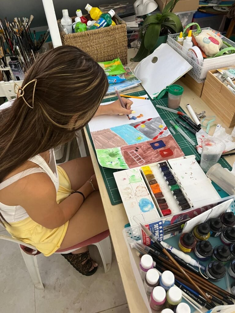 Person Painting on Canvas at a Table