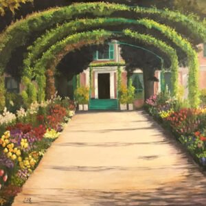 A pathway lined with colorful flowers and arched greenery leading to a building entrance.