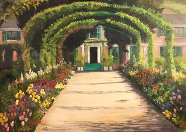 A pathway lined with colorful flowers and arched greenery leading to a building entrance.