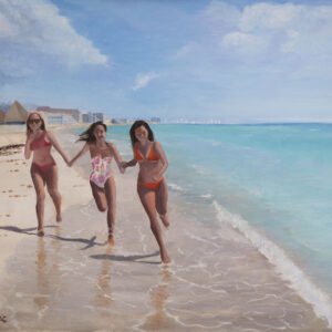 Three women in swimsuits running along the shoreline of a beach with water and sky in the background.
