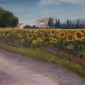 A pathway running through a field of sunflowers with a distant farmhouse and trees.