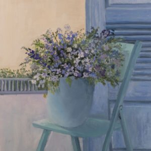 Light blue chair with a large flower pot filled with purple and white flowers.